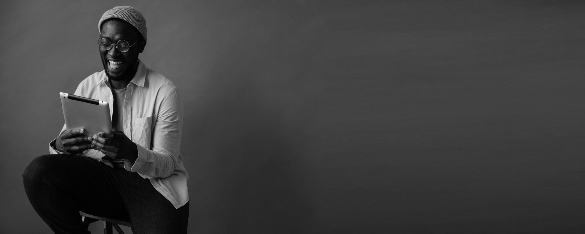Smiling man using ipad